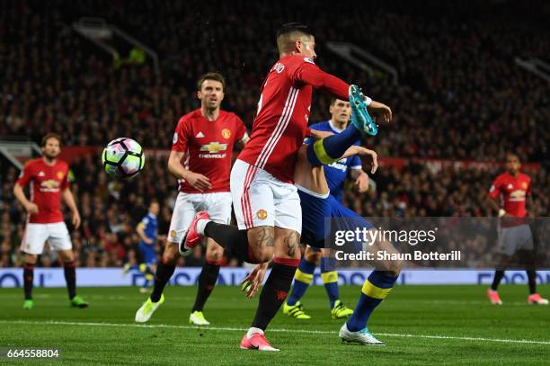 Phil Jagielka of Everton scores his sides first goal during the Premier League match between Manchester United and Everton at Old Trafford on April...