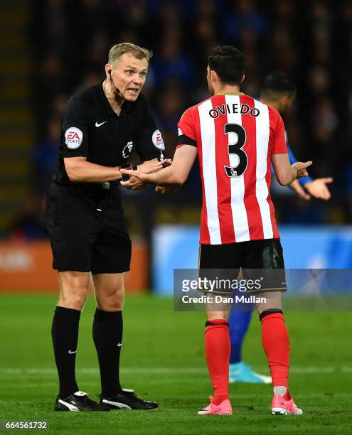 Referee Graham Scott has a word with Bryan Oviedo of Sunderland during the Premier League match between Leicester City and Sunderland at The King...
