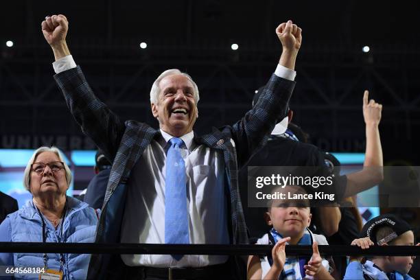 Head coach Roy Williams of the North Carolina Tar Heels watches 'ONE SHINING MOMENT' with his wife Wanda and their grandchildren following their...