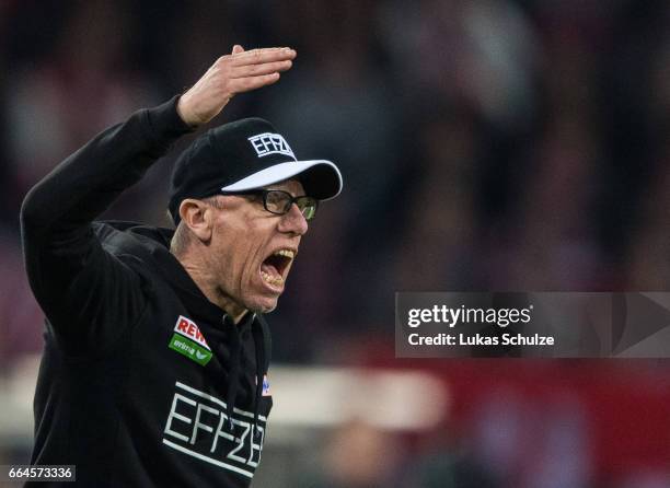 Head Coach Peter Stoeger of Koeln reacts on the side line during the Bundesliga match between 1. FC Koeln and Eintracht Frankfurt at...