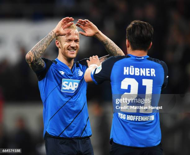 Kevin Vogt of 1899 Hoffenheim congratulates Benjamin Huebner after victory in the Bundesliga match between TSG 1899 Hoffenheim and Bayern Muenchen at...