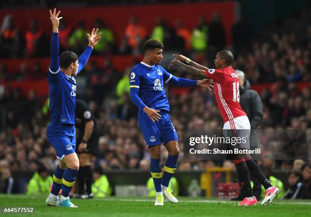 Mason Holgate of Everton and Ashley Young of Manchester United confront each other during the Premier League match between Manchester United and...