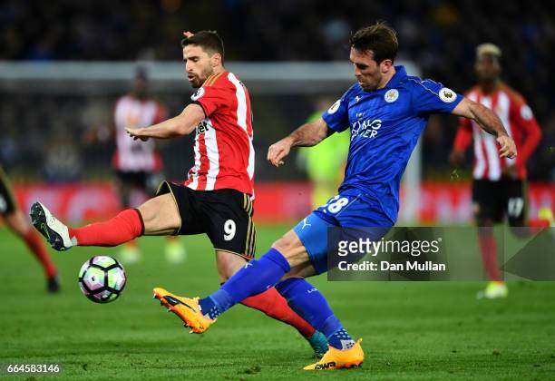 Christian Fuchs of Leicester City crosses the ball while Fabio Borini of Sunderland attempts to block during the Premier League match between...