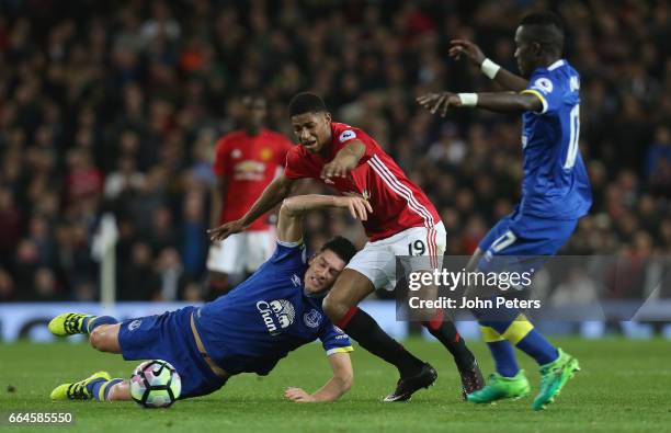 Marcus Rashford of Manchester United in action with Gareth Barry of Everton during the Premier League match between Manchester United and Everton at...