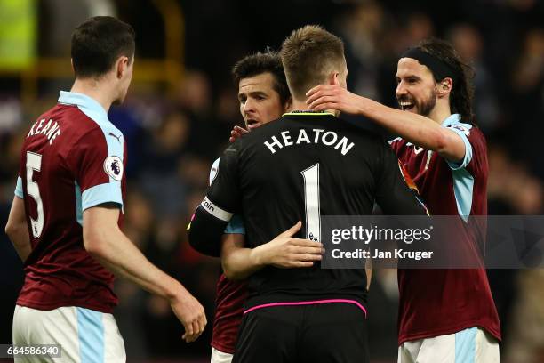 Joey Barton of Burnley, Thomas Heaton of Burnley and George Boyd of Burnley emrbace each other after the Premier League match between Burnley and...