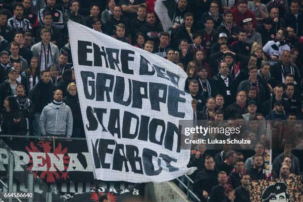 Fans of Frankfurt wave a flag with the print "Ehre der Gruppe Stadionverbot" during the Bundesliga match between 1. FC Koeln and Eintracht Frankfurt...