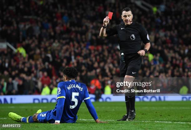 Referee Neil Swarbrick shows Ashley Williams of Everton a red card during the Premier League match between Manchester United and Everton at Old...