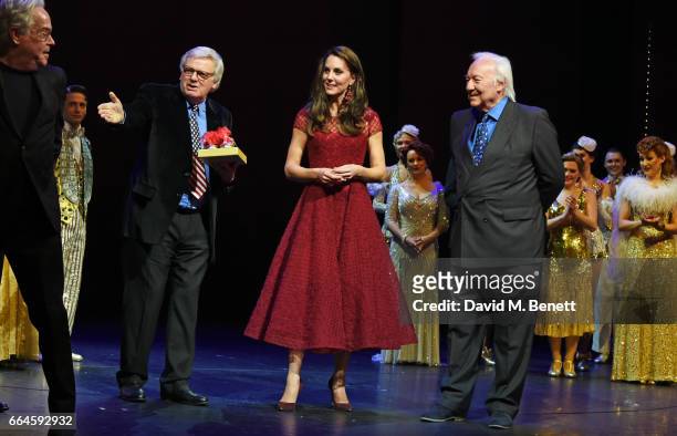 Catherine, Duchess of Cambridge, accepts a gift of tap shoes from producers Michael Linnet and Michael Grade during the Opening Night Royal Gala...