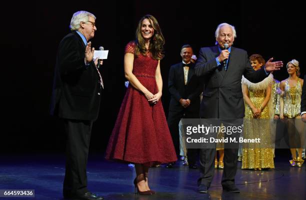 Catherine, Duchess of Cambridge and producers Michael Linnet and Michael Grade speak during the Opening Night Royal Gala performance of "42nd Street"...
