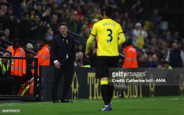Miguel Angel Britos of Watford walks towards Walter Mazzarri manager of Watford after being sent off during the Premier League match between Watford...