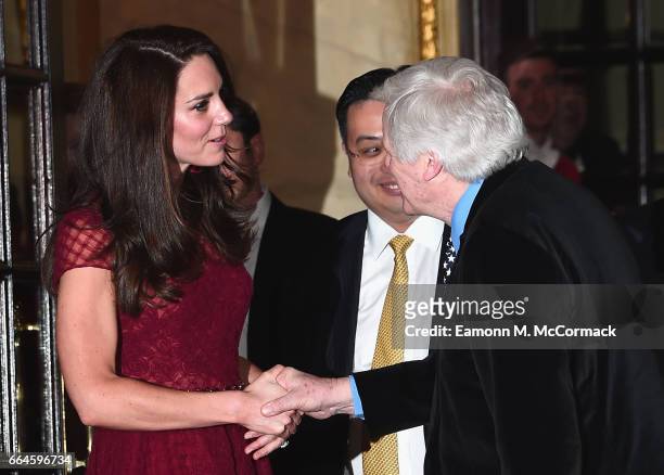 Catherine, Duchess of Cambridge shakes the hand of Lord Michael Grade as she is seen leaving the opening night of "42nd Street" at Theatre Royal on...