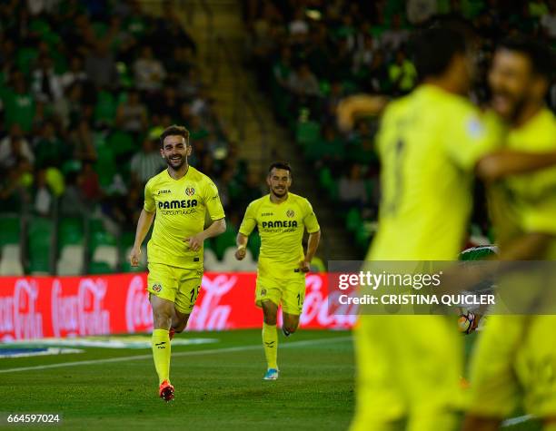 Villarreal's forward Adrián López Álvarez celebrates past Villarreal's German forward Nicola Sansone after scoring during the Spanish league football...