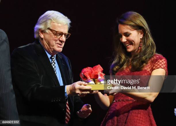 Catherine, Duchess of Cambridge, is presented with tap shoes by producer Michael Grade during the Opening Night Royal Gala performance of "42nd...