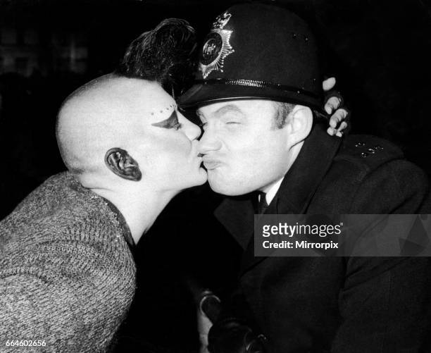 New Years Reveller 1984. So Friendly: A policeman is kissed by a girl punk in Trafalgar Square as 1984 begins, 1st January 1984.