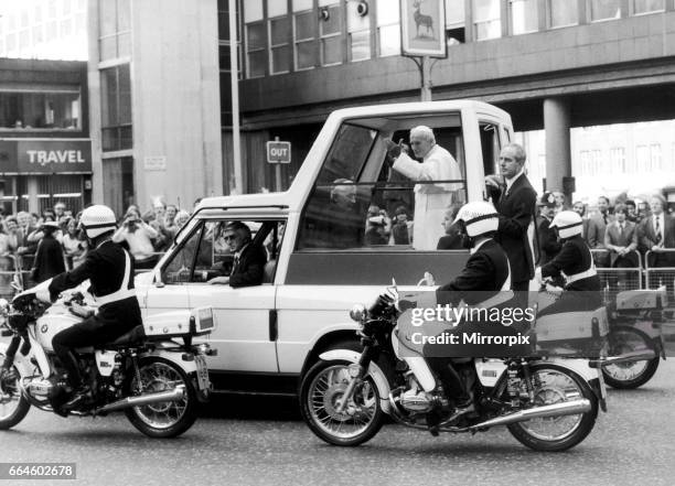 The Pope's visit to the United Kingdom May 1982. Pope John Paul II seen here waving to the crowds from the pope-mobile as he drives through Victoria,...