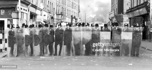 Policemen with riot shields form a cordon during the riots in Brixton April 11th 1981. The riots were sparked off by the stabbing of a black youth...