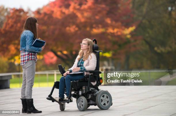 college friends standing outdoors on campus - motorized wheelchair stock pictures, royalty-free photos & images