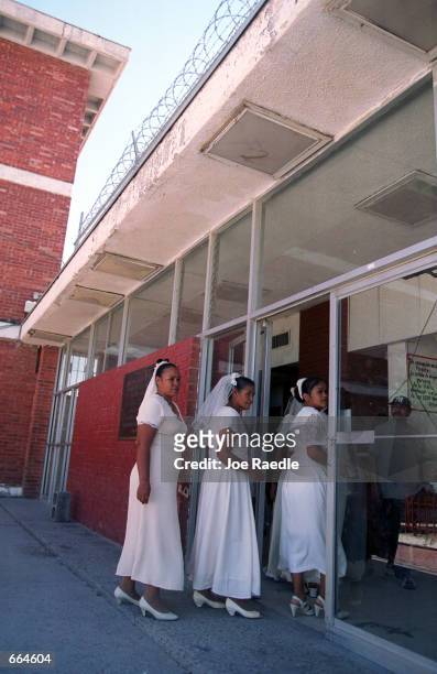 Brides enter a prison October 2, 2000 in Ciudad Juarez, Mexico. Mexican law allows for inmates to marry inside prison walls. 5 couples, one current...