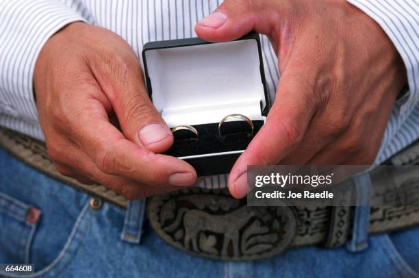 Wedding rings are presented during a wedding ceremony inside a prison October 2, 2000 at Ciudad Juarez, Mexico. Mexican law allows for inmates to...