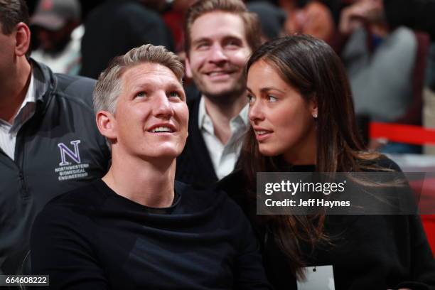 German football player Bastian Schweinsteiger and his wife Ana Ivanovic attend the game between the Cleveland Cavaliers and the Chicago Bulls on...