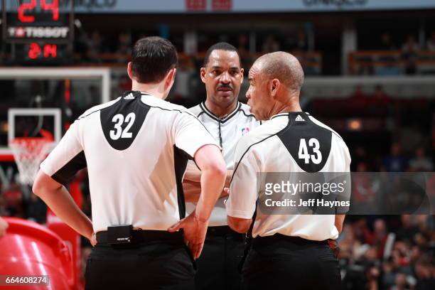 Referees Marat Kogut, Bennie Adams, and Dan Crawford talk things over during the game between the Chicago Bulls and the Cleveland Cavaliers on March...