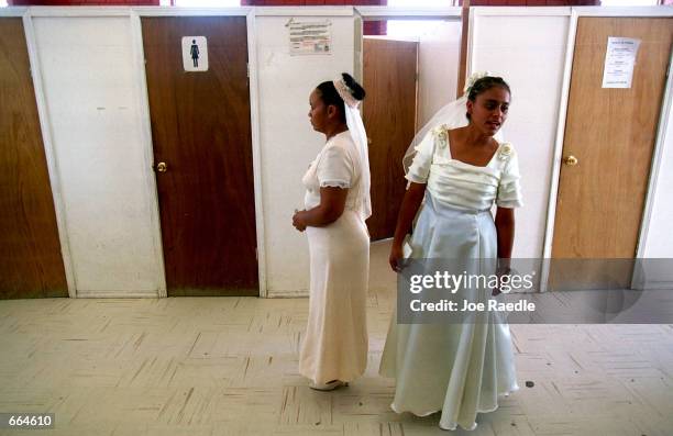 Brides wait to be searched in private rooms as they enter a prison October 2, 2000 in Ciudad Juarez, Mexico. Mexican law allows for inmates to marry...