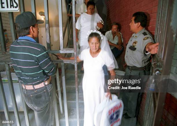 Brides are escorted through security gates into a prison October 2, 2000 in Ciudad Juarez, Mexico. Mexican law allows for inmates to marry inside...