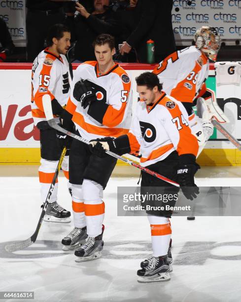 Samuel Morin and Mike Vecchione of the Philadelphia Flyers skate out for warmups prior to playing in their first NHL game against the New Jersey...