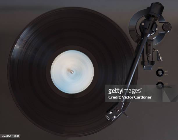 vinyl record played on a turntable - tocadiscos fotografías e imágenes de stock