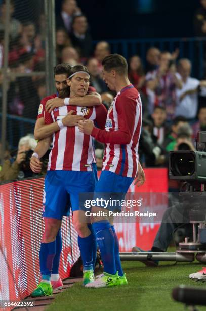 Filipe Luis of Atletico de Madrid celebrates with teammates Yannick Carrasco, Fernando Torres and Saul after scoring his team's winning goal during...