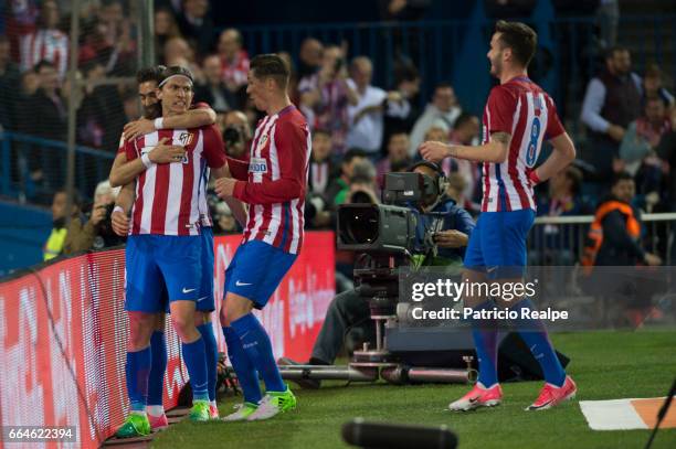 Filipe Luis of Atletico de Madrid celebrates with teammates Yannick Carrasco, Fernando Torres and Saul after scoring his team's winning goal during...