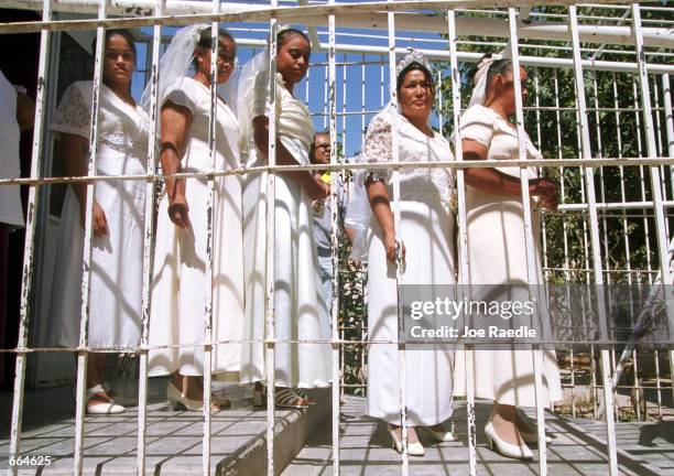 Brides file through a prison October 2, 2000 at Ciudad Juarez, Mexico. Mexican law allows for inmates to marry inside prison walls. 5 couples, one...