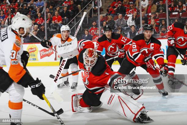 Keith Kinkaid of the New Jersey Devils reaches across to make the first period save on Colin McDonald of the Philadelphia Flyers at the Prudential...