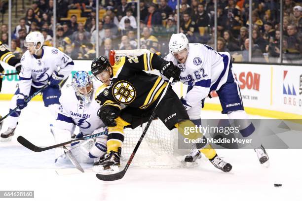 Andrej Sustr of the Tampa Bay Lightning defends Riley Nash of the Boston Bruins during the first period at TD Garden on April 4, 2017 in Boston,...