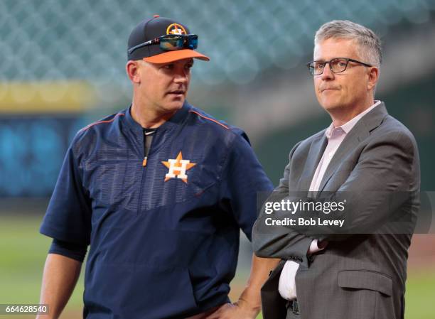 Manager A.J. Hinch of the Houston Astros and general manager Jeff Luhnow talk during batting practice at Minute Maid Park on April 4, 2017 in...