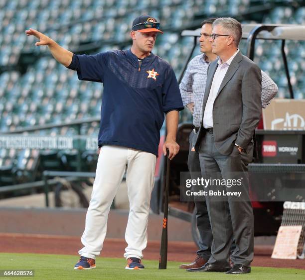 Manager A.J. Hinch of the Houston Astros and general manager Jeff Luhnow talk during batting practice at Minute Maid Park on April 4, 2017 in...