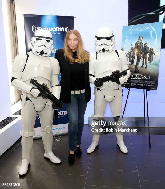 Bebe Buell poses with Stormtroopers for Blu-Ray release of Rouge One at SiriusXM Studios on April 4, 2017 in New York City.