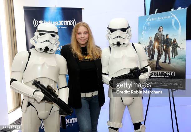 Bebe Buell poses with Stormtroopers for Blu-Ray release of Rouge One at SiriusXM Studios on April 4, 2017 in New York City.