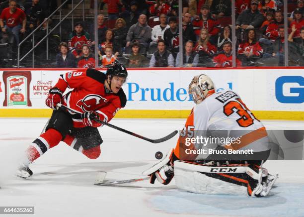 Taylor Hall of the New Jersey Devils is stopped by Steve Mason of the Philadelphia Flyers during the second period at the Prudential Center on April...