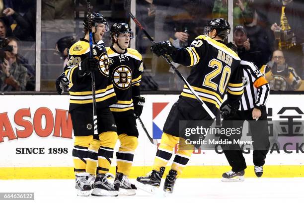 David Pastrnak of the Boston Bruins celebrates with Torey Krug and Riley Nash during the second period against the Tampa Bay Lightning at TD Garden...
