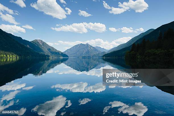 mirror reflections, the sky and clouds reflected in the surface of hte water of lake crescent. - olympic peninsula stock pictures, royalty-free photos & images