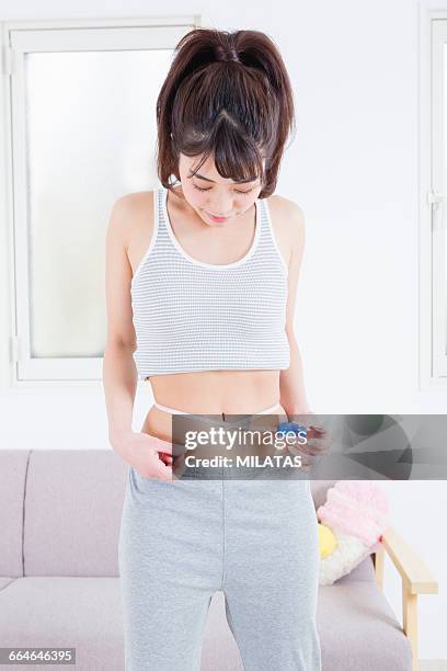 japanese woman to measure the waist - fat hips stock pictures, royalty-free photos & images