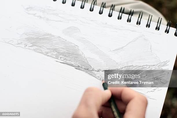 cropped image of person sketching on paper - sketch pad stock pictures, royalty-free photos & images