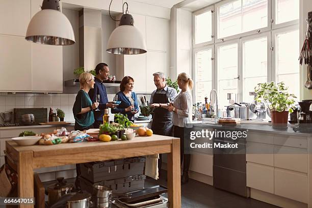 chef showing savoy cabbage to students while standing in kitchen - home economics class stock pictures, royalty-free photos & images