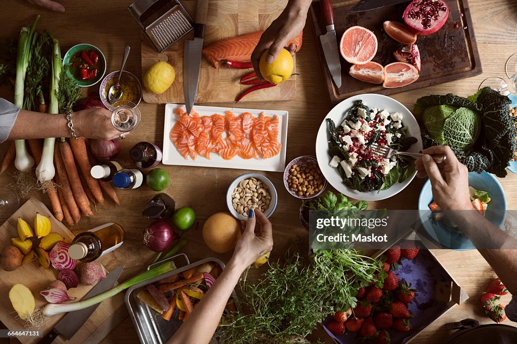 Cropped image of hands preparing food on table