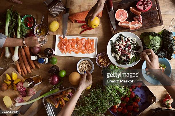 cropped image of hands preparing food on table - salmon seafood stock pictures, royalty-free photos & images