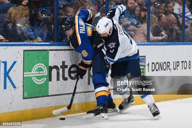 Magnus Paajarvi of the St. Louis Blues and Mark Stuart of the Winnipeg Jets battle for the puck on April 4, 2017 at Scottrade Center in St. Louis,...