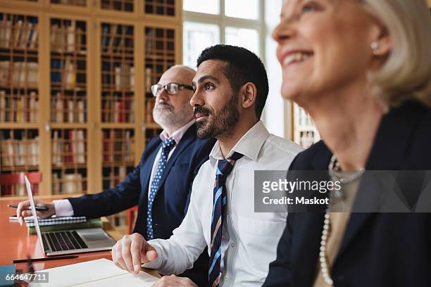 male and female professionals listening in meeting - lawyer computer stock pictures, royalty-free photos & images
