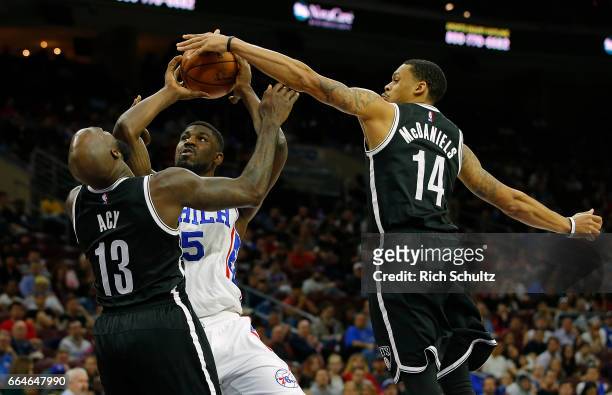 Alex Poythress of the Philadelphia 76ers attempts a shot as Quincy Acy and KJ McDaniels of the Brooklyn Nets defend in the second half during an NBA...