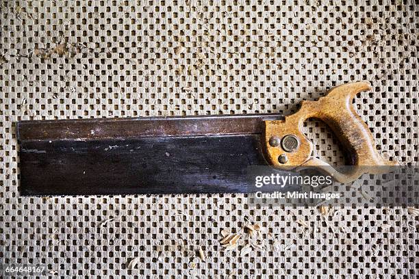 close up of a dovetail saw in a carpentry workshop. - dovetail stock pictures, royalty-free photos & images